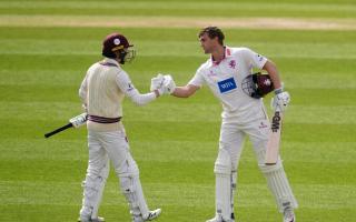 Somerset's Tom Lammonby (right) celebrates his century with team mate Lewis Goldsworthy against Surrey at the Kia Oval.