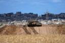 An Israeli tank overlooks the Gaza Strip (Tsafrir Abayov/AP)