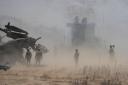 Dust billows as Philippine Army fires Atmos 155mm howitzers during a joint military exercise in Laoag, Ilocos Norte (Aaron Favila/AP)