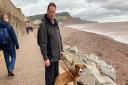 Dave Rafferty and his dog Rogan at the site of the planned beach access ramp
