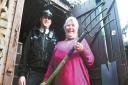 Eileen Burke and her garden fork with PC Jon O'Connor. Picture: County Gazette