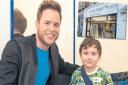 Olly Murs with Aiden and inset the charity shop in Taunton. Picture: County Gazette