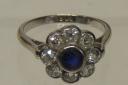 STUNNING: An 18ct white gold ring set with sapphire and surrounded by diamonds in flower head form realising £500