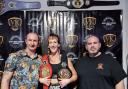 Lucy with her team and the belts