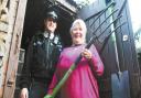 Eileen Burke and her garden fork with PC Jon O'Connor. Picture: County Gazette