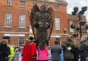 Speakers stand next to the newly unveiled Knife Angel sculpture outside the Market House in Taunton.