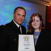 Toni is pictured receiving her award from Supt Trevor Margenout, of Avon and Somerset Police.