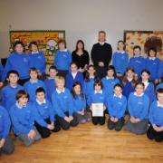 Pictured with their award back at school are the year six children