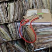 A stethoscope on top of patient's files. Pic: PA