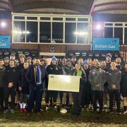 James Kew, of British Gas, and Taunton rugby players present the cheque to CHSW area fundraiser Mary Gray. Picture: CHSW