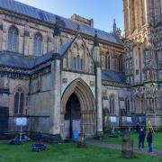 Film crews setting up camera equipment at Wells Cathedral.
