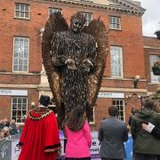 Speakers stand next to the newly unveiled Knife Angel sculpture outside the Market House in Taunton.