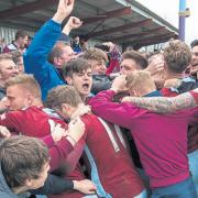 Taunton Town players and fans celebrate after confirmation came through that Taunton had wrapped up the title.