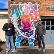 Inkie left and Rob Chambers in front of the M&H cricketing mural