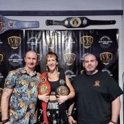 Lucy with her team and the belts