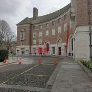 Red paint and graffiti were daubed on the County Hall building in Taunton town centre three times