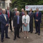 NEW BEGINNINGS: Alan Goddard, centre, with the Cornish Mutual Board of Directors outside the new office in Willand