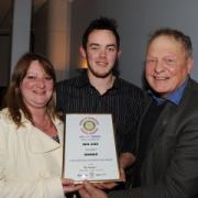 Pictured with Ben at the ceremony are mum Tracy and granddad Robert Woolley