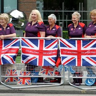 Gamesmakers line the route of the Great Britain Athletes Victory Parade near St Paul's Cathedral