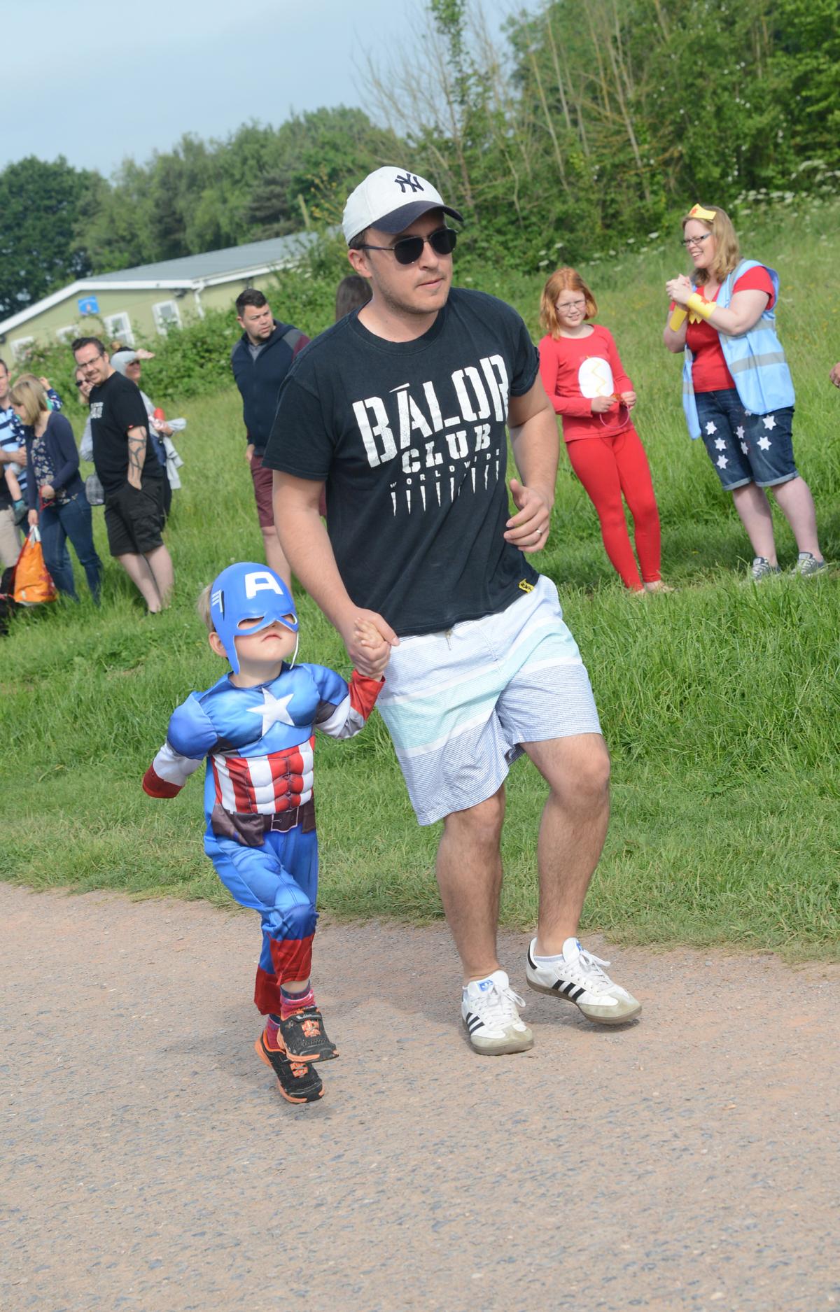 Many runners, families and volunteers got into costume for the day's superhero theme.