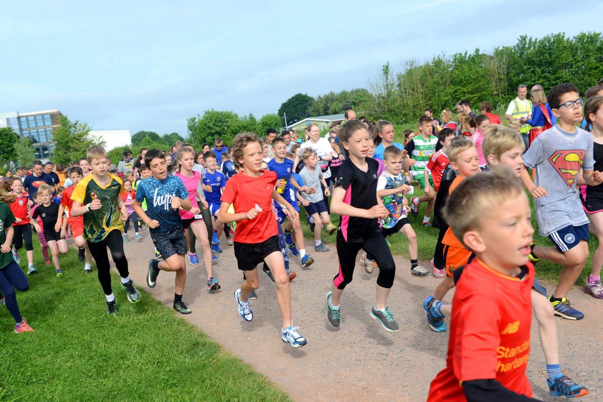 The runners set off for Junior Parkrun's 100th race in Longrun Meadow.