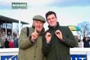 Paul Nicholls left and his assistant Charlie Davies celebrate passing the 100 winners for the season. Picture: PPAUK