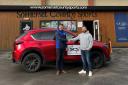 Jack Scadden right collecting the car from Harry Clements of Somerset County Sports