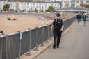 A police officer on Exmouth seafront - they will soon be backed up by community patrols
