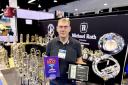 Rob Hanson with two awards won by John Packer Musical Instruments.