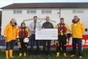 DONATION: A good week for Minehead Barbarians on and off the field, as chairman Stewart Ford and president Grahame Symes present a £1,000 cheque to Minehead RNLI representatives.