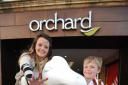 Sophie Durdan-Adams and Sam Durdan-Bone are pictured getting ready to put their print on a blank dragon outside Taunton's orchard shopping centre.