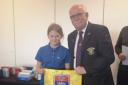 Taunton & Pickeridge captain Kevin Jackson being presented with a souvenir flag signed by all who played on the day.