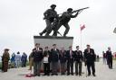 D-Day veterans pose for pictures at the British Normandy memorial statue.
