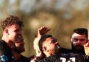 Elvis Taione surrounded by teammates after scoring the winning try