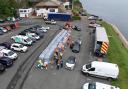 A drone view of people collecting bottled water at Freshwater car park in Brixham on Friday (Ben Birchall/PA)