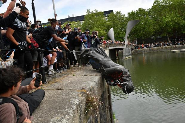 Somerset County Gazette: File photo dated 7/6/2020 of protesters throwing a statue of Edward Colston into Bristol harbour during a Black Lives Matter protest rally. Four people have been cleared at Bristol Crown Court of criminal damage for pulling down the statue. Issue date: