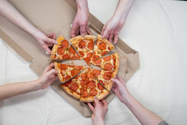 Somerset County Gazette: People sharing a Pepperoni pizza. Credit: Canva