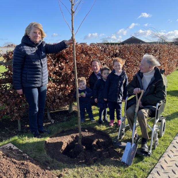 Somerset County Gazette: Jim Booth and Taunton School nursery students plant a tree to mark the Queen's Platinum Jubilee. Picture: Taunton School