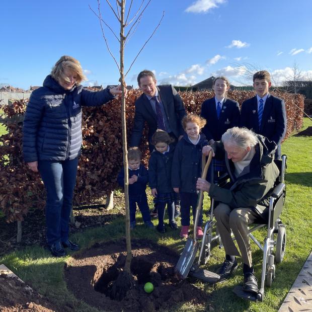 Somerset County Gazette: Jim Booth and Taunton School nursery students plant a tree to mark the Queen's Platinum Jubilee. Picture: Taunton School