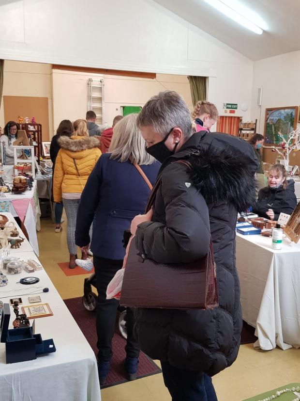 Somerset County Gazette: A craft fair shopper looks at the goods on offer. Picture: West Country Craft Fairs
