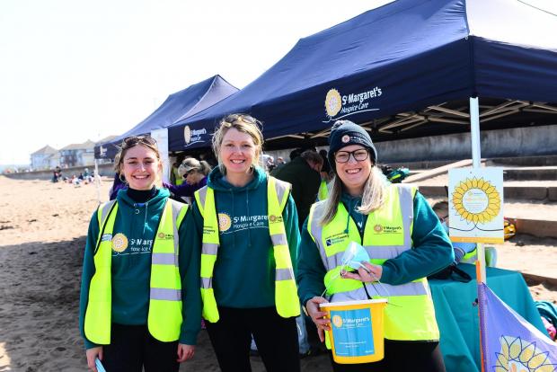 Somerset County Gazette: Ellie Weston, Amy Garland, and Hollie Cashmore of St Margaret's Hospice at Minehead Beach on Saturday. Picture: Steve Richardson