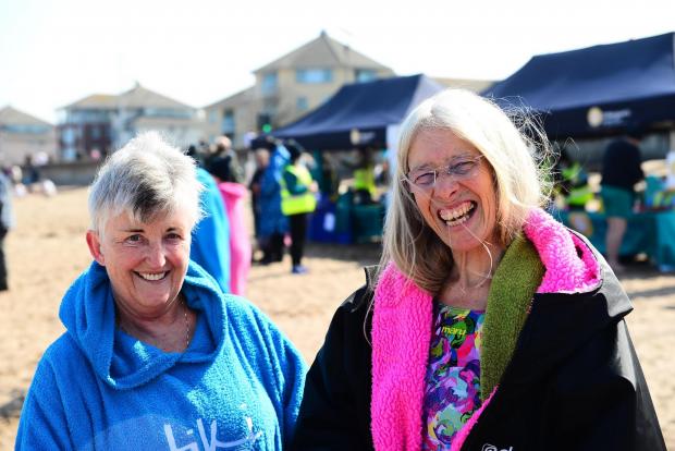Somerset County Gazette: Kate Allam and Ann Jordan wrapped up in warm clothing before entering the water.