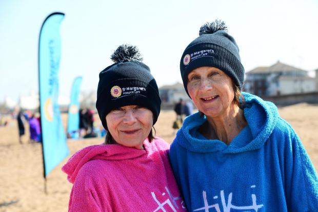 Somerset County Gazette: Glenys Tonks and Elaine Barras don their new St Margaret's Hospice bobble hats in Minehead.