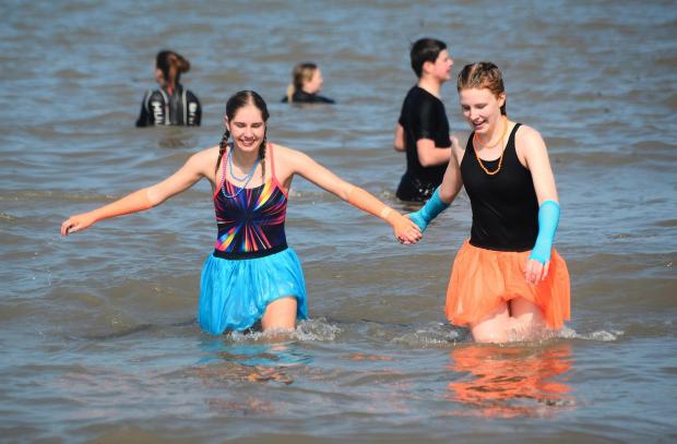 Somerset County Gazette: Colour-coordinated St Margaret's supporters in the sea at Minehead Beach.