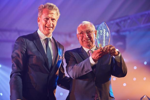 Somerset County Gazette: John, grandfather of Glastonbury-raised F1 driver Lando Norris, collected the award on his behalf. Picture: Millfield School