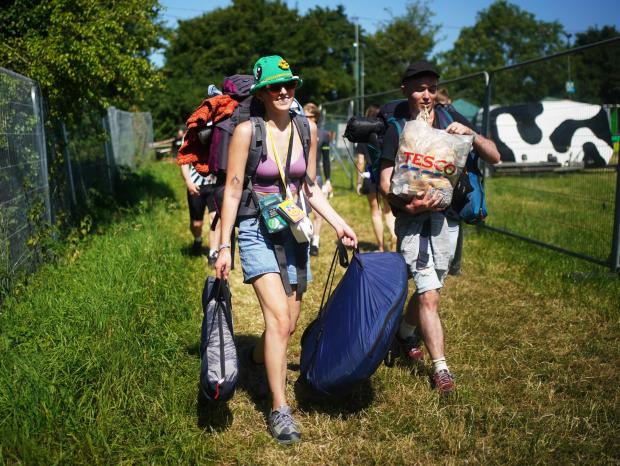 Somerset County Gazette: People arrive on the first day of the Glastonbury Festival at Worthy Farm in Somerset (PA/PA Wire. Photo by Yui Mok