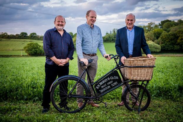 Somerset County Gazette: Robin Huish (Current MD), David Henderson (Financial Director) & Duncan Meikle (Company Chairman) pictured with Hickleys original delivery vehicle