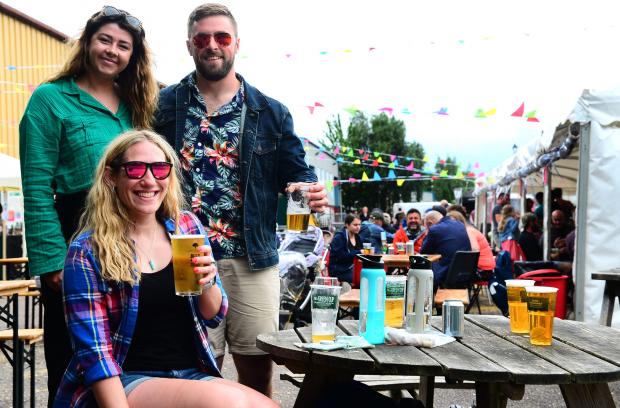 Somerset County Gazette: Millie Flintham, Lucy Halford, and Jake Elsmore at Quantock Brewery's Bishops Lydeard taproom. Pictures: Steve Richardson
