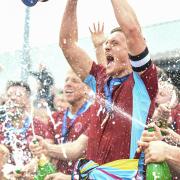 Nick Grimes lifts the Southern League trophy after Taunton's promotion in 2022. Image: Clayton Jane