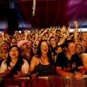 The crowd watch Glastonbury founder Michael Eavis performing with his band in the William's Green tent during the Glastonbury Festival at Worthy Farm. PA.